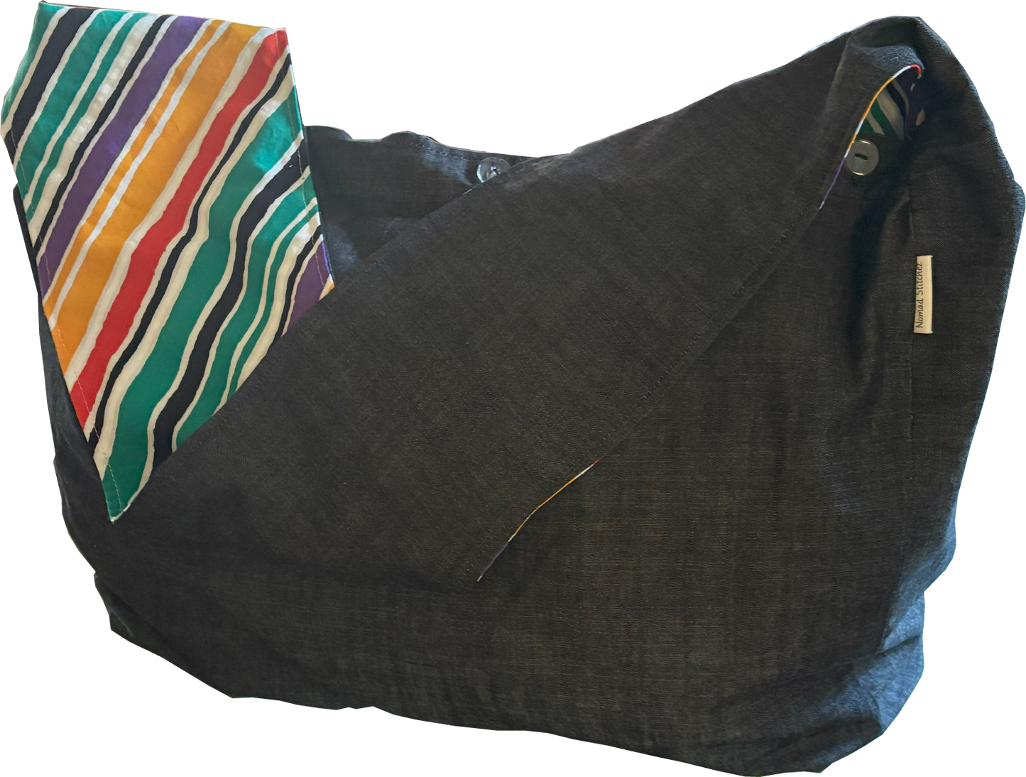 Front view of Nomad Stitchez Black Denim Sling Bag with bold bias-cut stripe in primary colors.