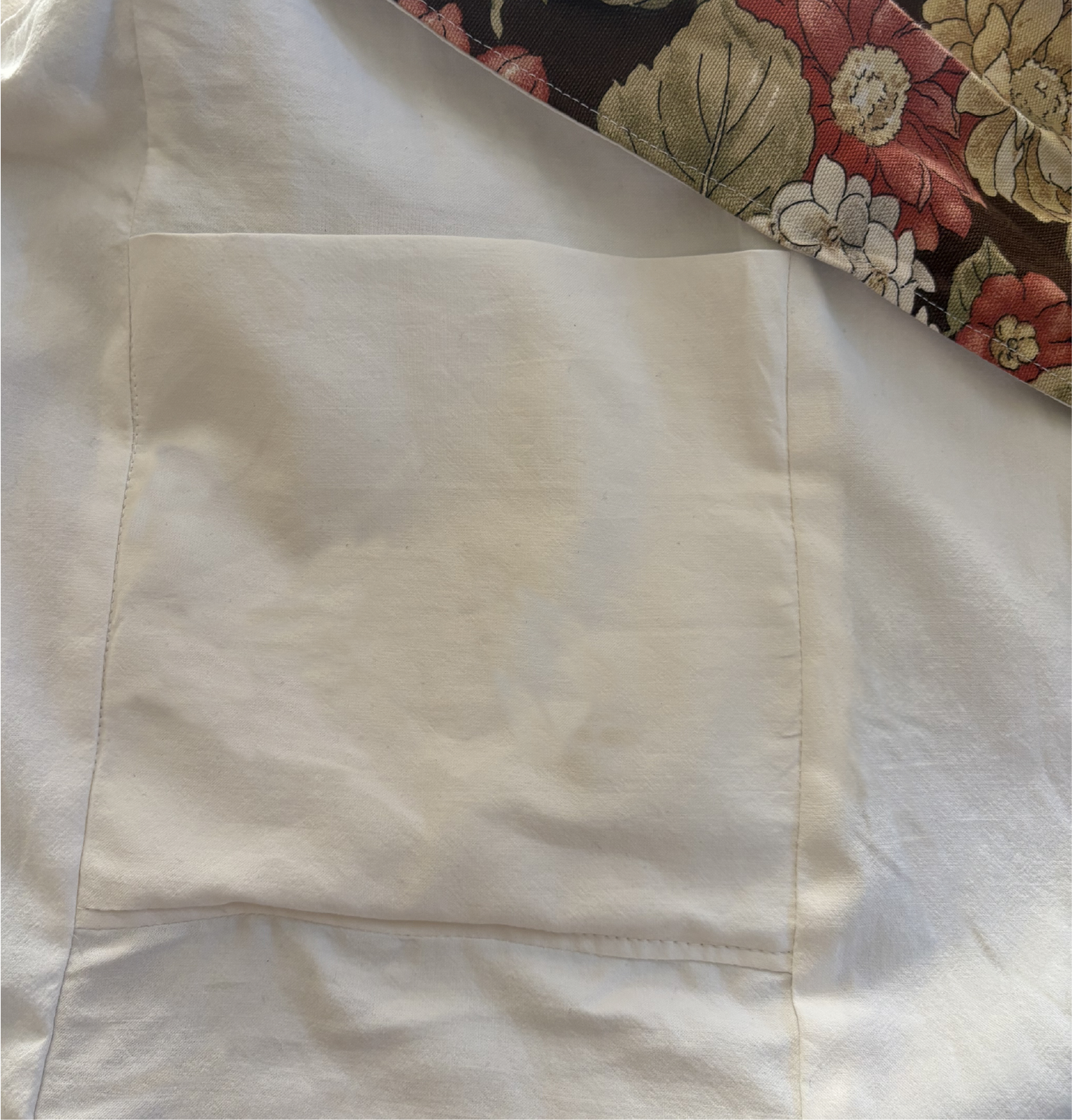 Interior view of Cinnamon Flora Twill Sling Bag with internal pockets for organized storage.