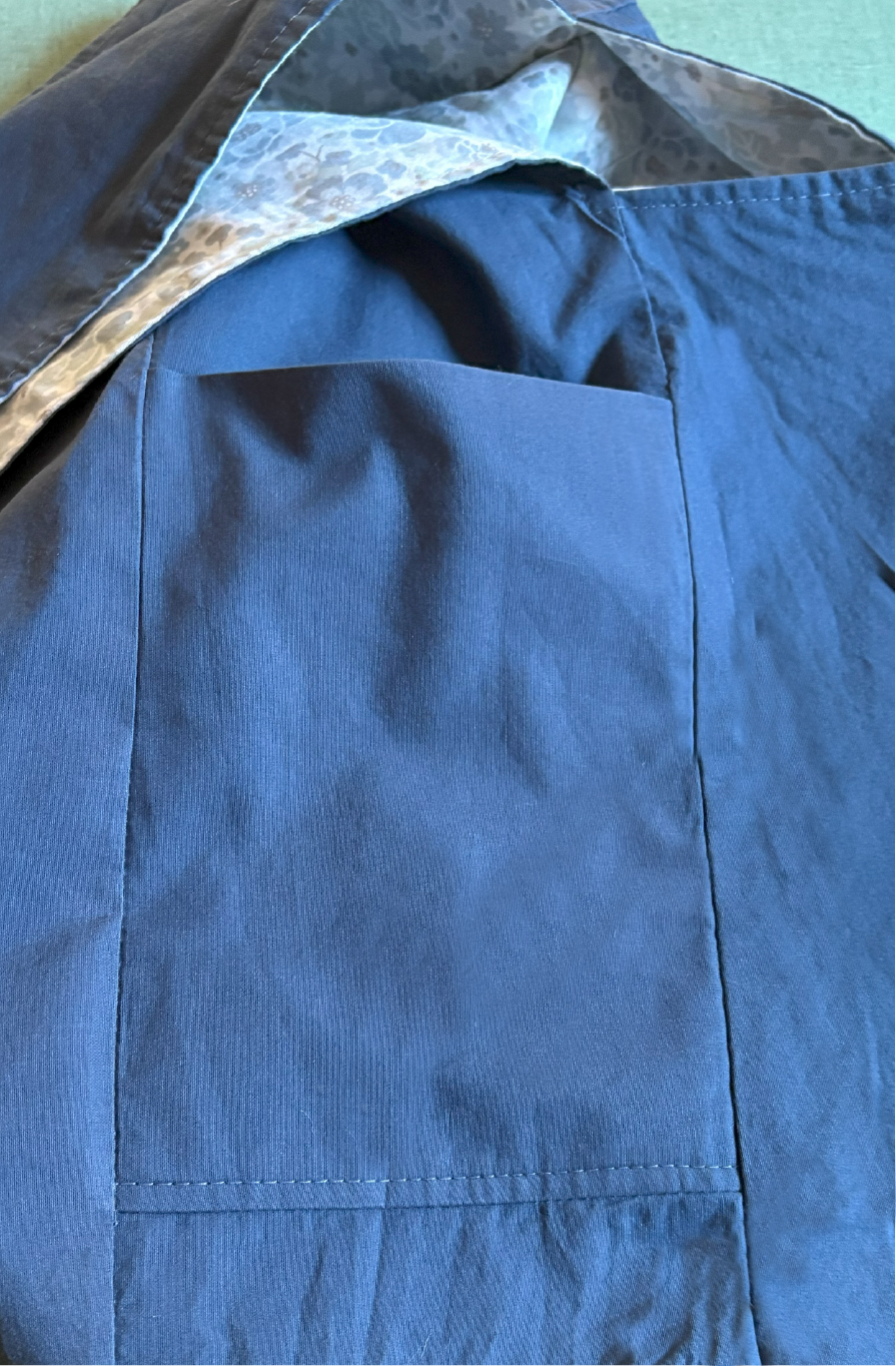 Close-up of the solid blue lining and interior pocket of the 1/2 Pint ~ Stitch Shoulder Bag in soft blue ditsy floral, designed for easy organization.