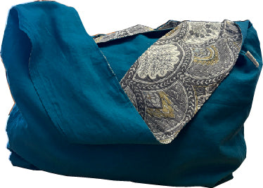 Linen sling bag made from repurposed linen with a simple, natural design and adjustable strap.