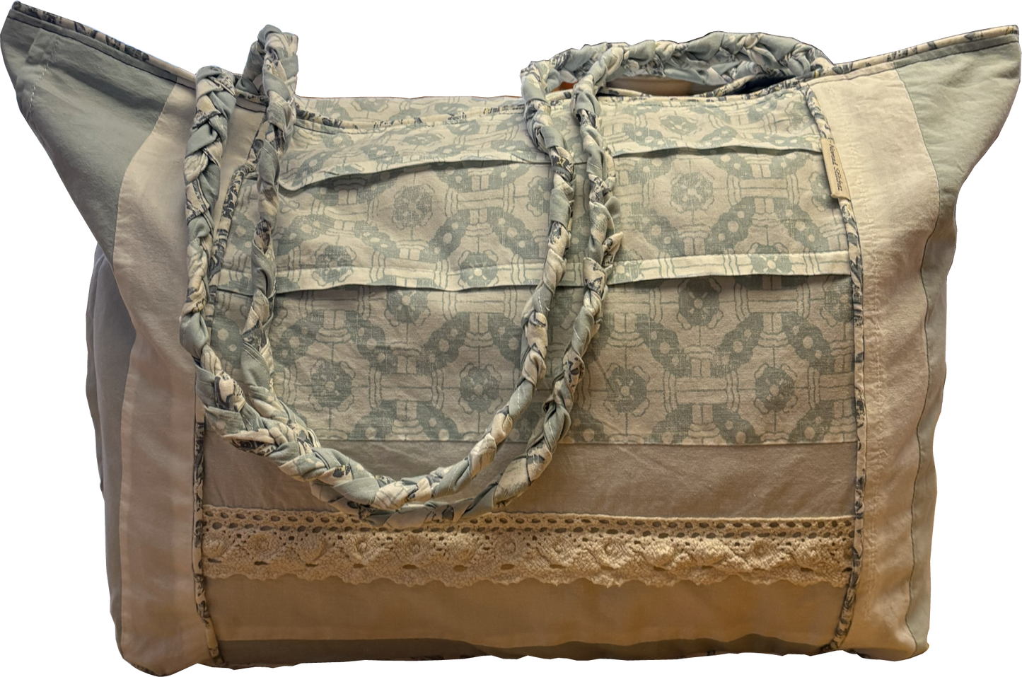 Boho Chic Leigh Bag made from repurposed cotton fabrics, featuring blue and white prints with coordinating solid panels, cotton lace trim. and braided handle.