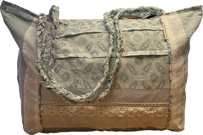 Boho Chic Leigh Bag made from repurposed cotton fabrics, featuring blue and white prints with coordinating solid panels, cotton lace trim. and braided handle.