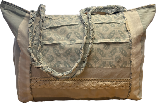 Boho Chic Leigh Bag made from repurposed cotton fabrics, featuring blue and white prints with coordinating solid panels, cotton lace trim. and braided handle.
