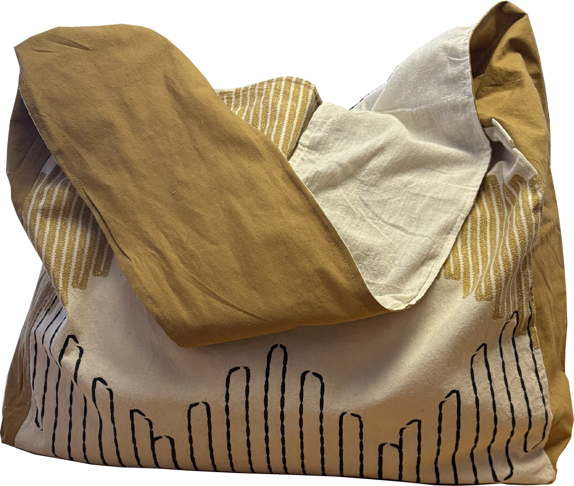 Mustard and black printed sling bag with a solid mustard yellow strap and natural cotton muslin lining.