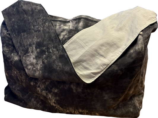 Black and white tie-dye sling bag with a solid interior lining and fixed-length strap.