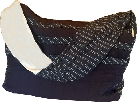 Front view of the Quilted Cotton Sling Bag showing the navy quilted shell, navy/white striped strap, and sleek crossbody design from the 2nd Time Around Collection.