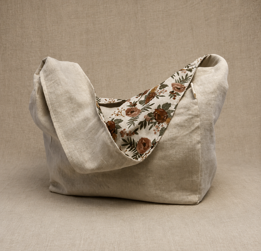 Front view of the Evergreen Rose 1/2-Pint Stitch Bag featuring a soft floral print with rust, blush, and evergreen tones on a natural linen-look fabric with structured front pocket detailing.