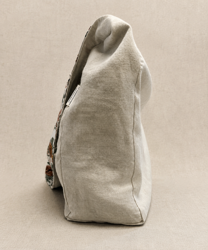 Side view of the Evergreen Rose 1/2-Pint Stitch Bag showcasing the curved silhouette, soft linen-look fabric, and botanical floral print in rust, blush, and evergreen tones.