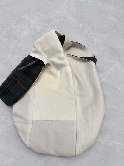 Pocket view of the Half-Pint Stitch Bag showing the navy plaid cotton shell, soft solid cotton lining, and interior storage pocket with handcrafted stitching details.