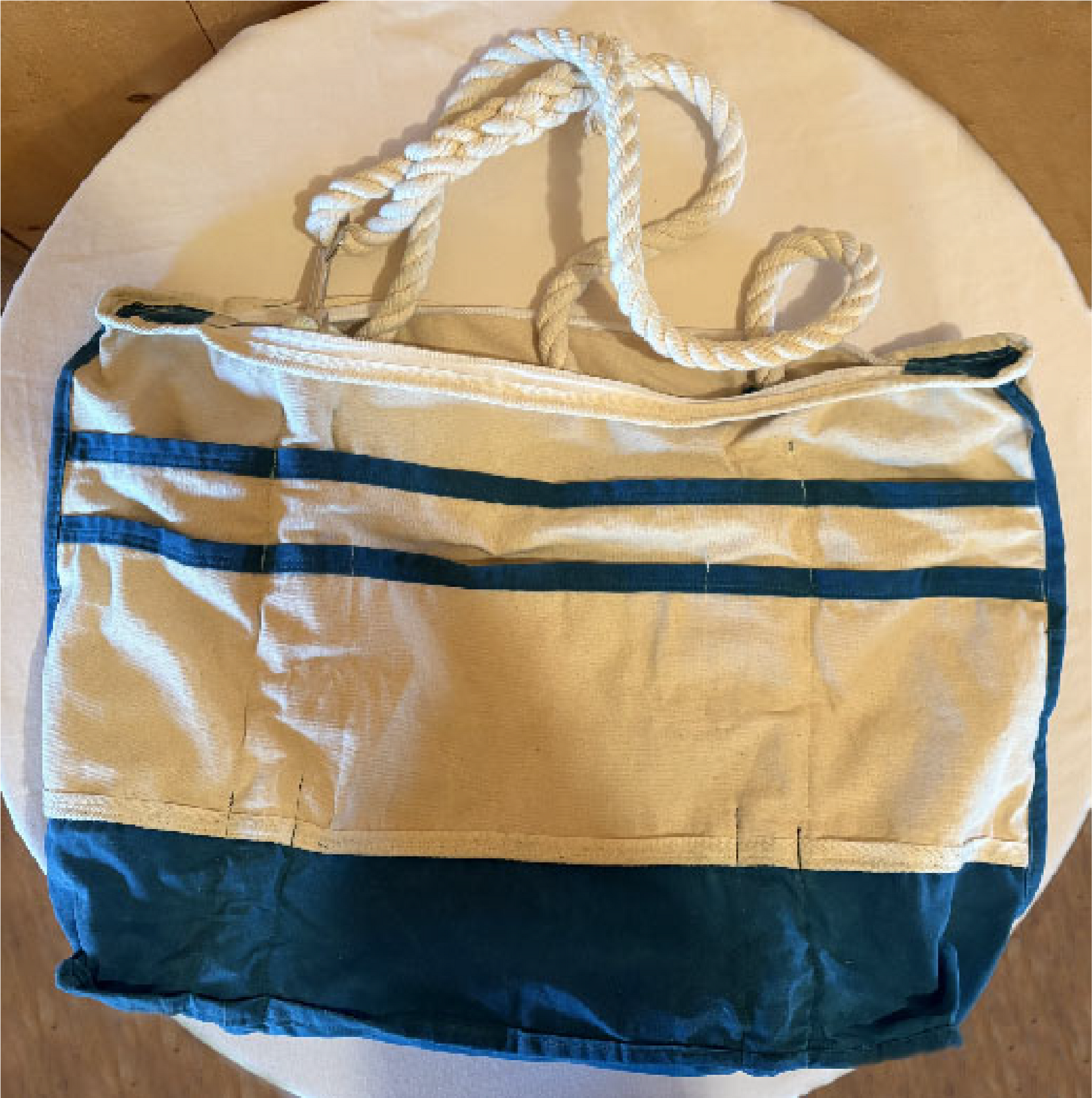 Two rows of natural canvas pockets trimmed in teal waxed canvas.