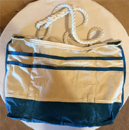 Two rows of natural canvas pockets trimmed in teal waxed canvas.