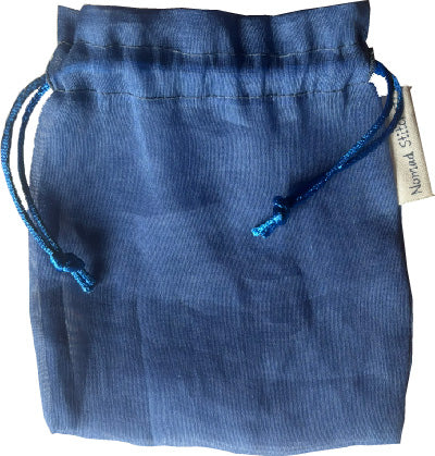 Periwinkle silk satchel with a soft sheen, featuring a drawstring closure—ideal for holding crystals, jewelry, or small keepsakes.