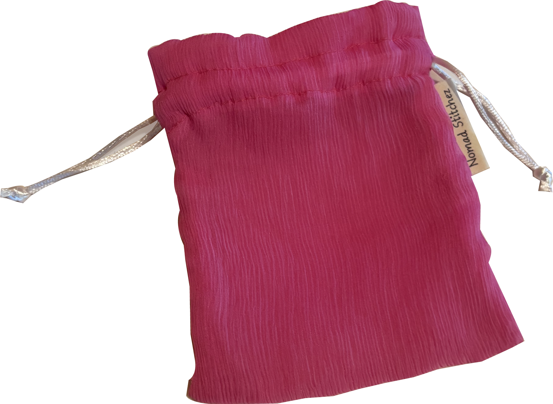 Pink silk satchel with a soft sheen, featuring a drawstring closure—ideal for holding crystals, jewelry, or small keepsakes.