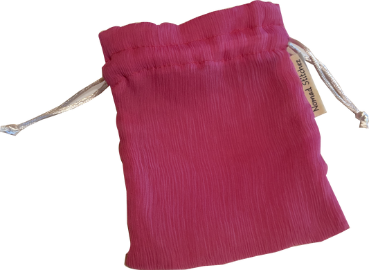 Pink silk satchel with a soft sheen, featuring a drawstring closure—ideal for holding crystals, jewelry, or small keepsakes.