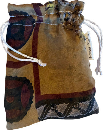 Earthtone Geo print silk satchel with a soft sheen, featuring a drawstring closure—ideal for holding crystals, jewelry, or small keepsakes.