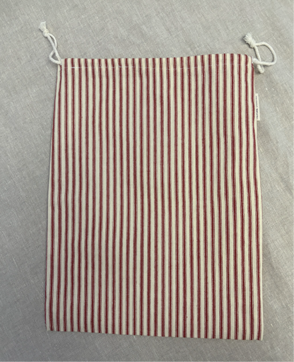 Vertical red stripe cotton utility bag with a cotton drawstring closure, 12in x 15in size, part of the Essentials Collection.