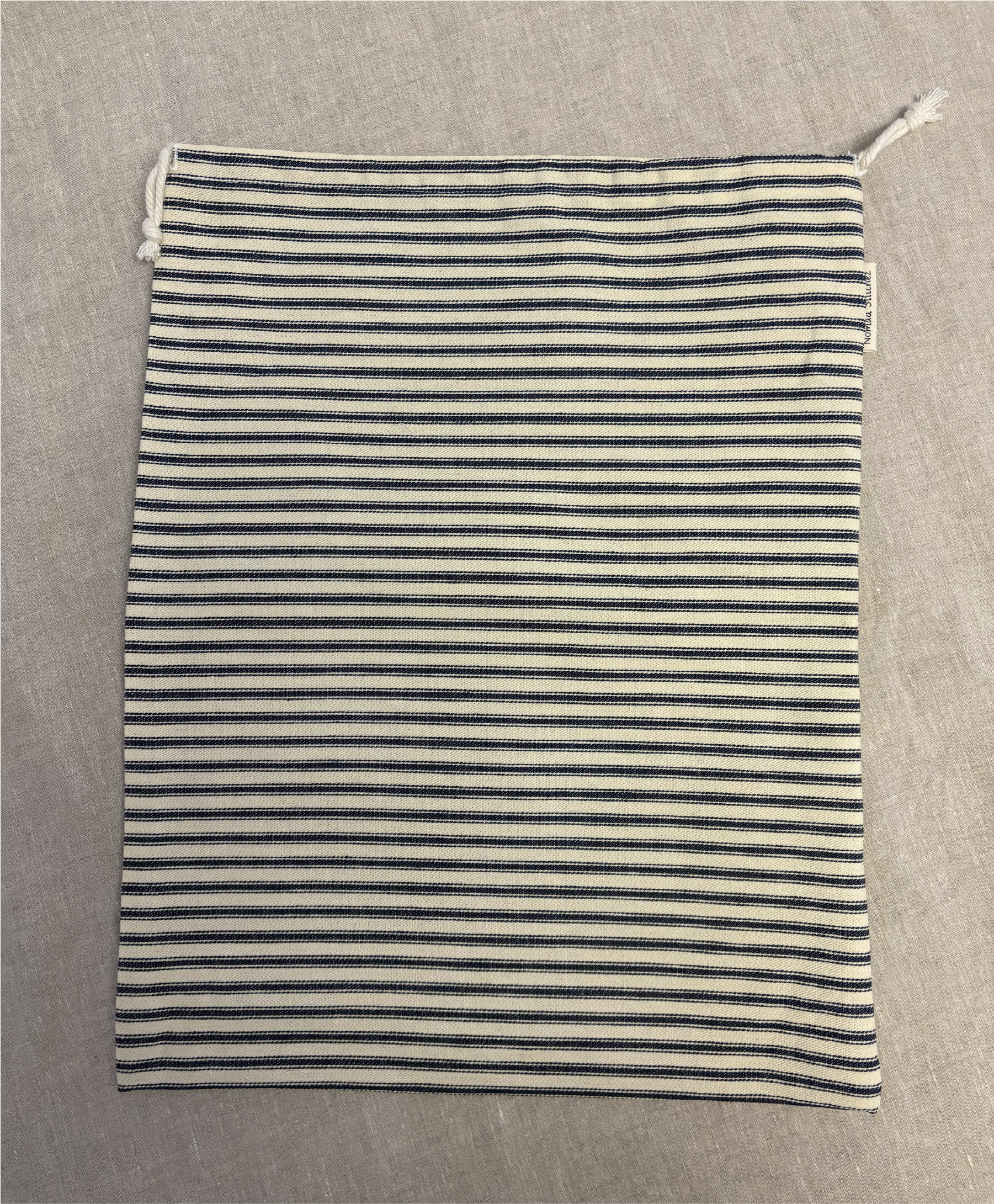 Vertical red stripe cotton utility bag with a cotton drawstring closure, 12in x 15in size, part of the Essentials Collection.